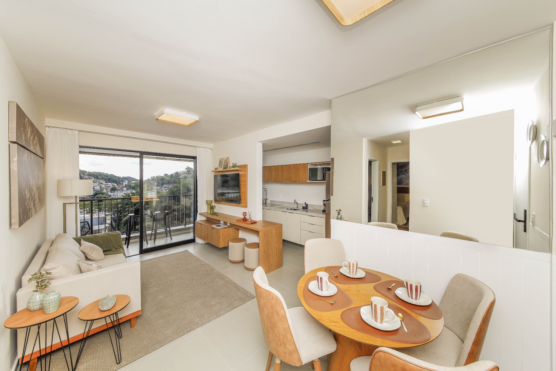Sala integrada com varanda, cozinha americana e mesa de jantar do decorado